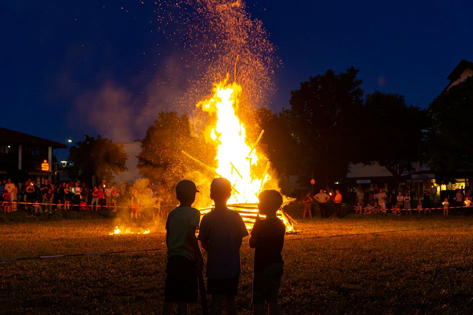 Children watching a big bonfire at night